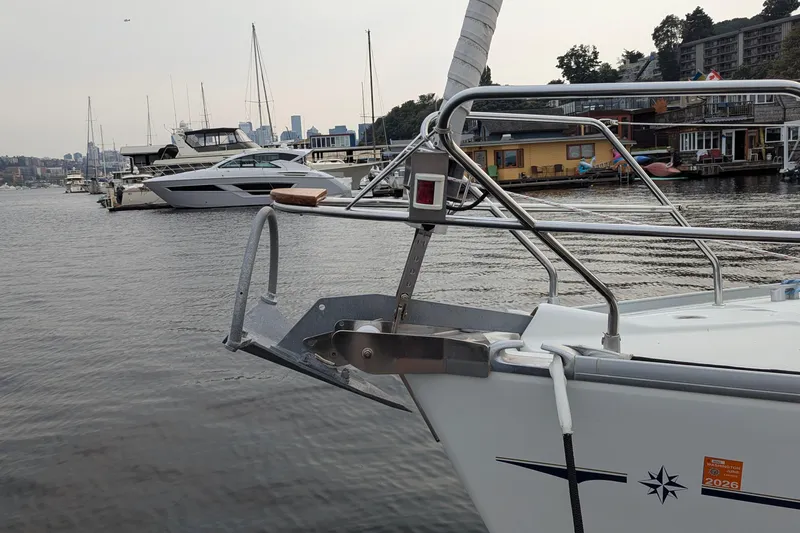 Slide: The Image of Bow of 2002 Jeanneau Sun Odyssey 37 sailboat docked in a marina with city skyline. - 5