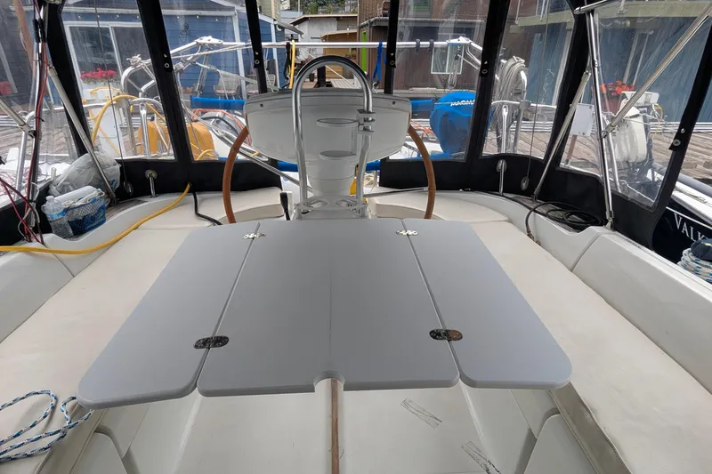 Slide: The Image of Cockpit of 2002 Jeanneau Sun Odyssey 37 sailboat with foldable table and steering wheel. - 6