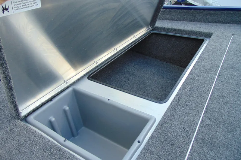 Slide: The Image of 2026 Crestliner 1700 Storm boat storage compartments with open lids, showcasing interior space. - 10