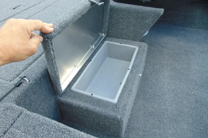 Slide: The Image of 2026 Crestliner 1700 Storm boat storage compartment with open lid, showcasing interior space. - 11