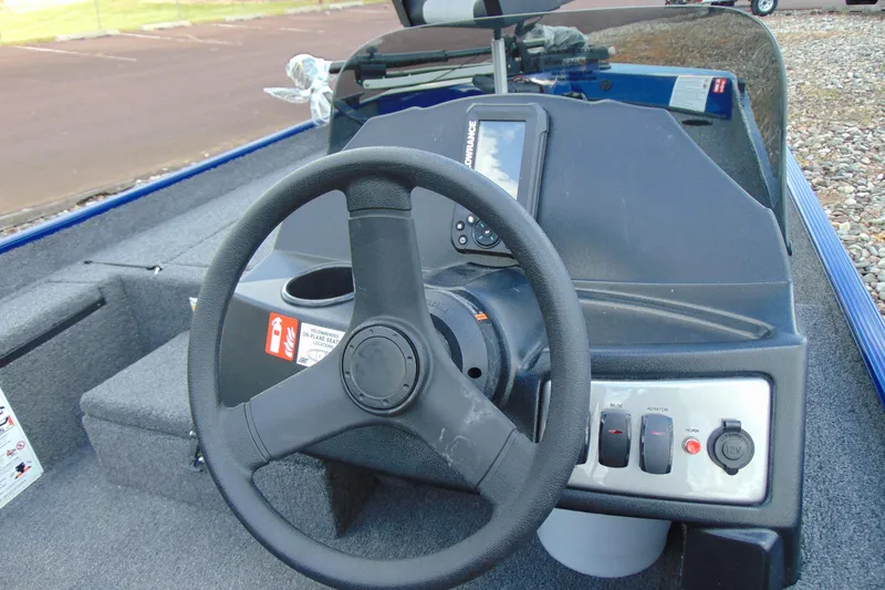 Slide: The Image of 2026 Crestliner 1700 Storm boat dashboard with steering wheel and control panel. - 12