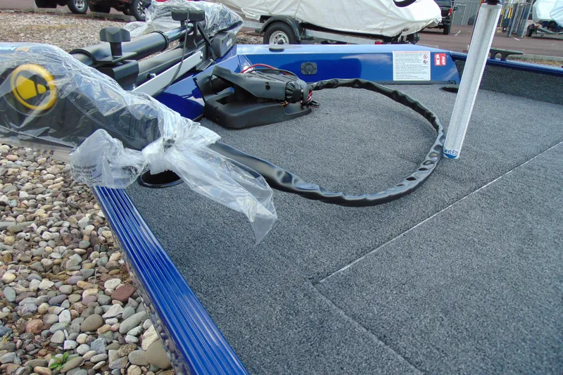 Slide: The Image of 2026 Crestliner 1700 Storm boat deck with fishing equipment and carpeted surface. - 8