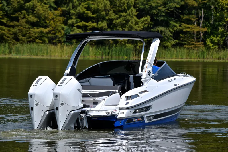 Slide: The Image of 2024 Monterey 305 Super Sport boat with dual engines on a serene lake. - 10