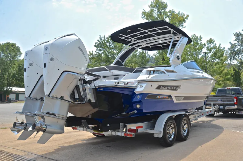 Slide: The Image of 2024 Monterey 305 Super Sport boat on trailer with dual outboard engines. - 16