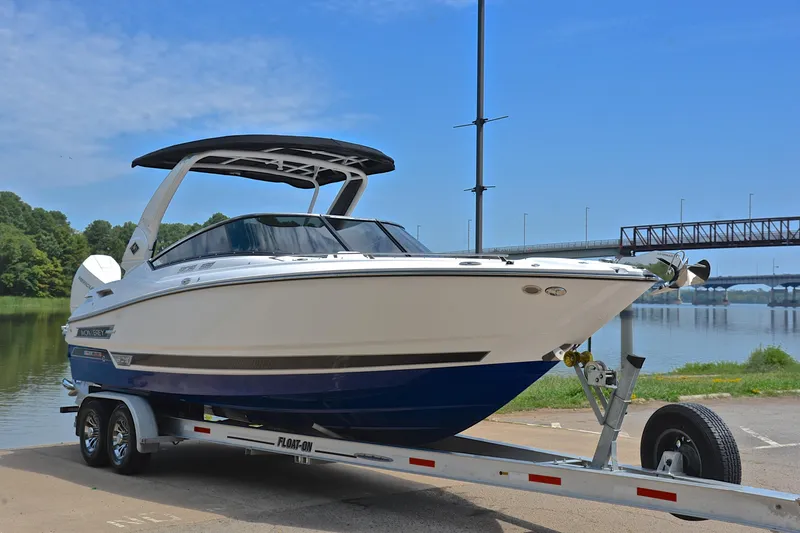 Slide: The Image of 2024 Monterey 305 Super Sport boat on trailer by a scenic river. - 18