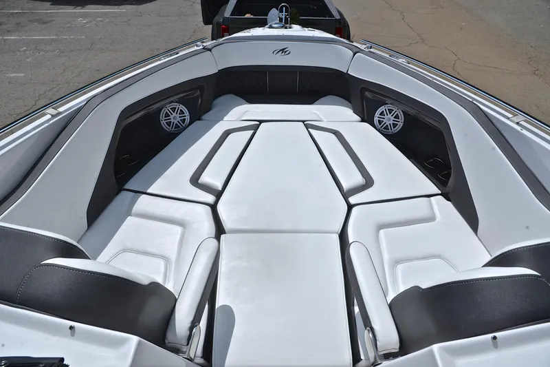 Slide: The Image of 2024 Monterey 305 Super Sport boat interior with white seating and speakers. - 23