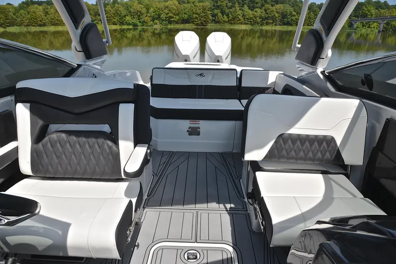 Slide: The Image of Luxurious interior of 2024 Monterey 305 Super Sport boat with stylish seating and lake view. - 24