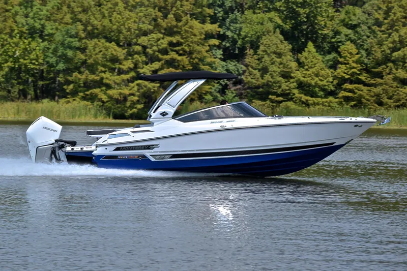 Slide: The Image of 2024 Monterey 305 Super Sport boat cruising on a lake with lush green trees. - 3
