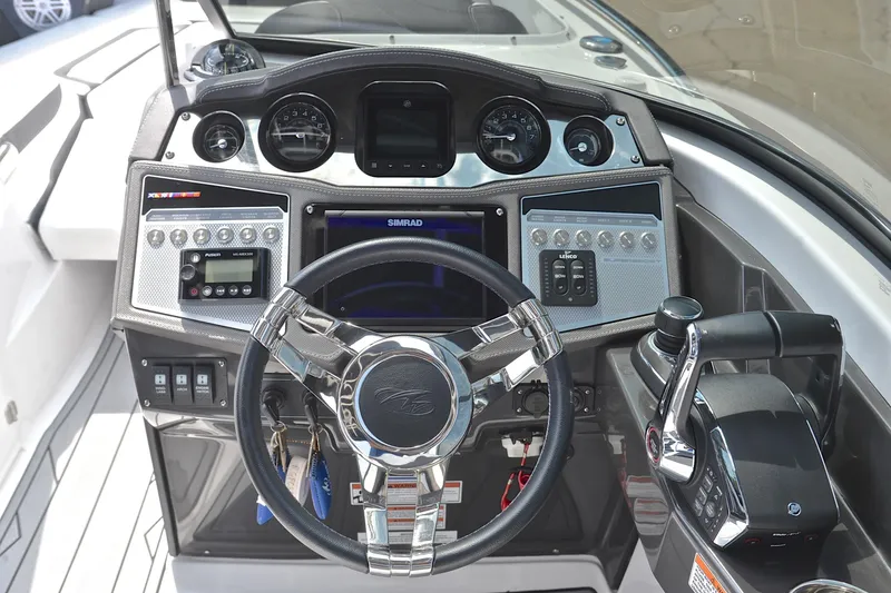 Slide: The Image of 2024 Monterey 305 Super Sport boat dashboard with steering wheel and control panel. - 30