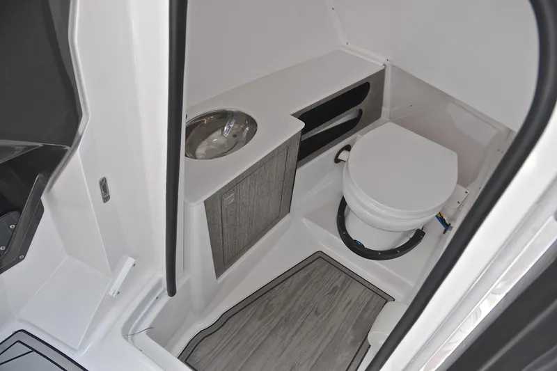 Slide: The Image of 2024 Monterey 305 Super Sport boat bathroom with modern sink and toilet. - 32