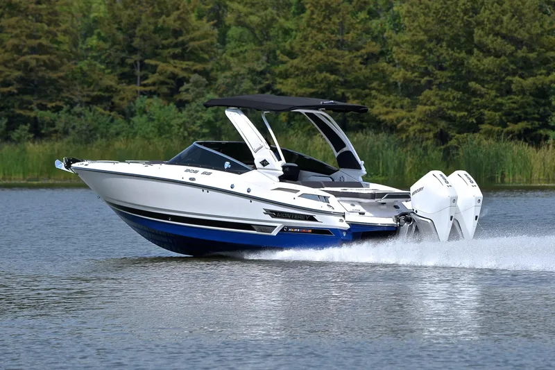 Slide: The Image of 2024 Monterey 305 Super Sport boat cruising on a lake with lush green trees. - 4