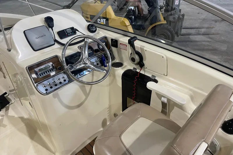 Slide: The Image of 2008 Scout 242 Dorado boat cockpit with steering wheel and navigation equipment. - 10