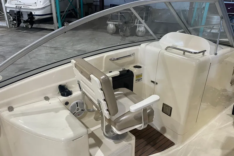 Slide: The Image of 2008 Scout 242 Dorado boat interior with seating and control panel. - 12