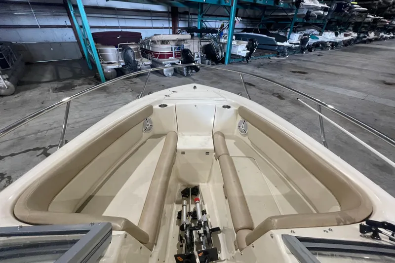 Slide: The Image of 2008 Scout 242 Dorado boat interior with beige seating in storage facility. - 15