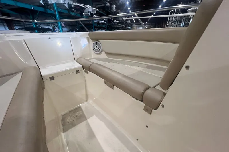 Slide: The Image of Interior view of 2008 Scout 242 Dorado boat with beige seating and storage. - 17