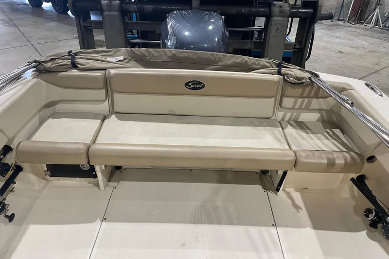 Slide: The Image of 2008 Scout 242 Dorado boat interior with beige seating and storage compartments. - 7