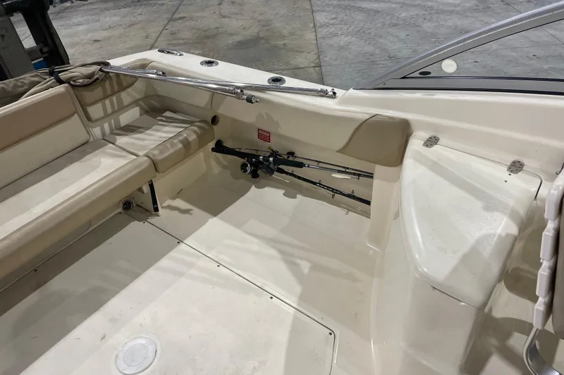 Slide: The Image of 2008 Scout 242 Dorado boat interior with beige seating and fishing rods. - 8