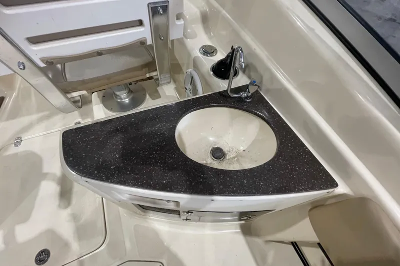 Slide: The Image of Boat sink area on 2008 Scout 242 Dorado with black countertop and faucet. - 9