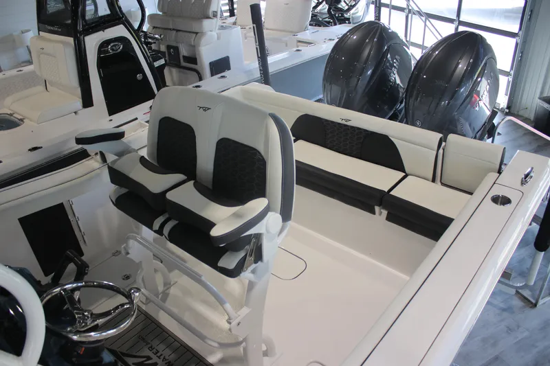 Slide: The Image of 2026 Tidewater 256 LXF boat interior with dual seats and twin outboard engines. - 10