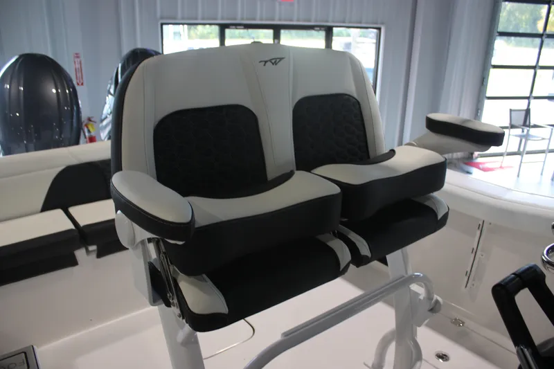 Slide: The Image of 2026 Tidewater 256 LXF boat seats with armrests in a showroom setting. - 12
