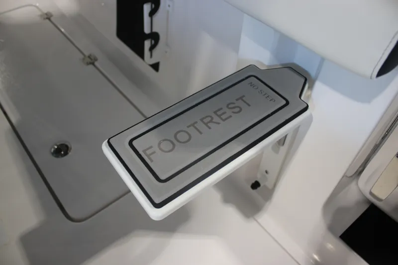 Slide: The Image of 2026 Tidewater 256 LXF boat footrest with "No Step" warning label. - 13