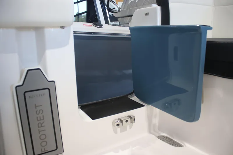 Slide: The Image of 2026 Tidewater 256 LXF boat interior, featuring footrest and seating details. - 14