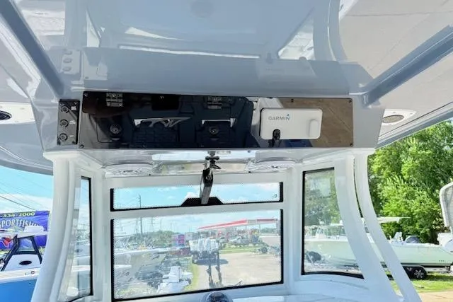 Slide: The Image of 2026 Tidewater 3100 Carolina Bay boat console with Garmin electronics and clear windshield. - 10