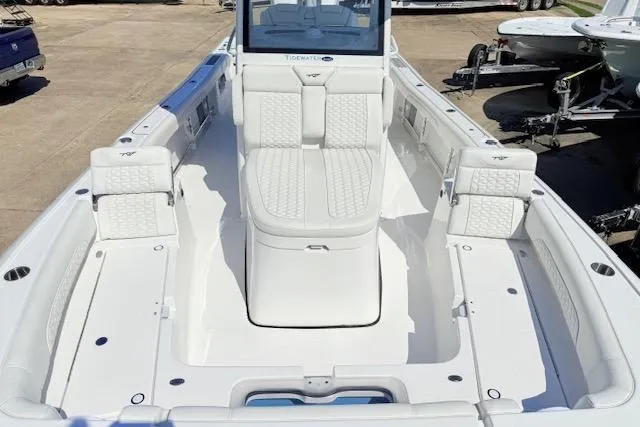 Slide: The Image of 2026 Tidewater 3100 Carolina Bay boat with white seating and spacious deck. - 12