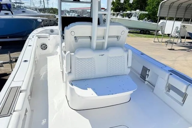 Slide: The Image of 2026 Tidewater 3100 Carolina Bay boat interior with seating and console, docked outdoors. - 4