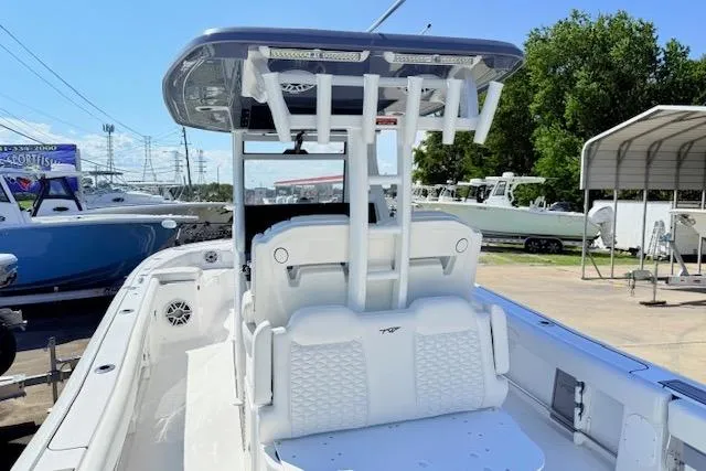 Slide: The Image of 2026 Tidewater 3100 Carolina Bay boat with T-top and seating, docked outdoors. - 5