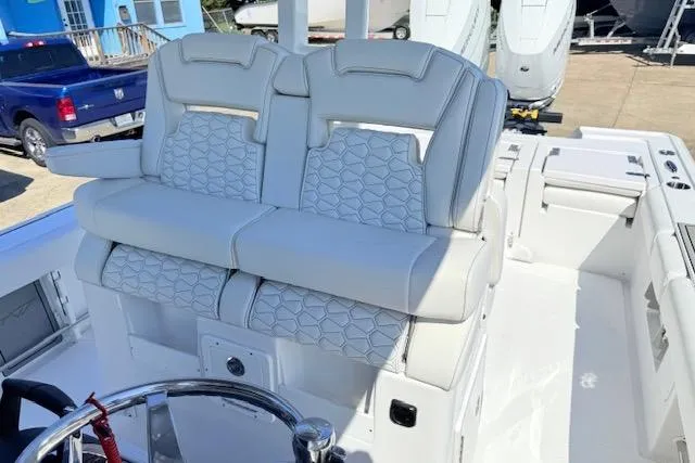Slide: The Image of 2026 Tidewater 3100 Carolina Bay boat interior with dual cushioned seats and steering wheel. - 7
