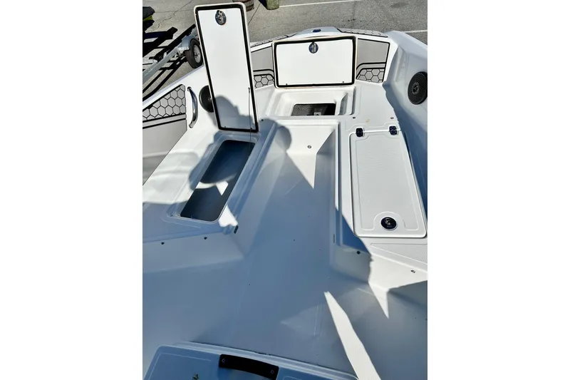Slide: The Image of 2021 Scarab 195 ID boat interior with open storage compartments and sleek design. - 14