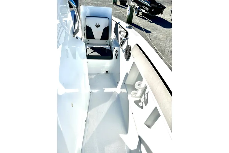Slide: The Image of Interior of 2021 Scarab 195 ID boat, featuring seating and storage compartments. - 17