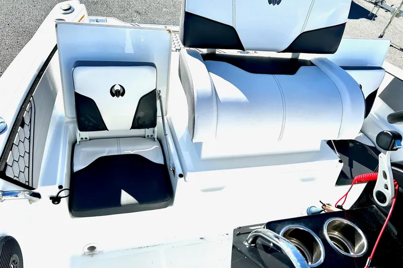 Slide: The Image of 2021 Scarab 195 ID boat interior with sleek white and black seating and control panel. - 22