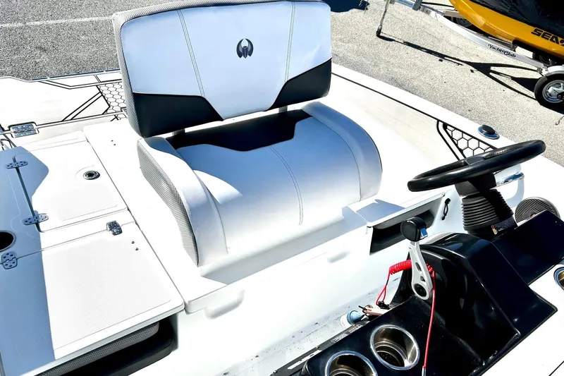 Slide: The Image of 2021 Scarab 195 ID boat interior with steering wheel and seating area. - 23