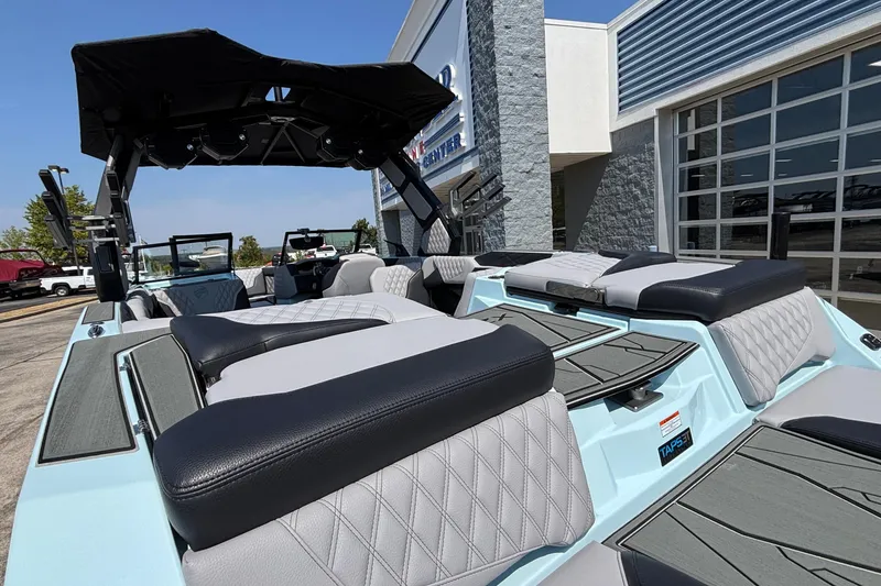 Slide: The Image of 2026 Tigé 24RZX boat with sleek seating and modern design at a dealership. - 11