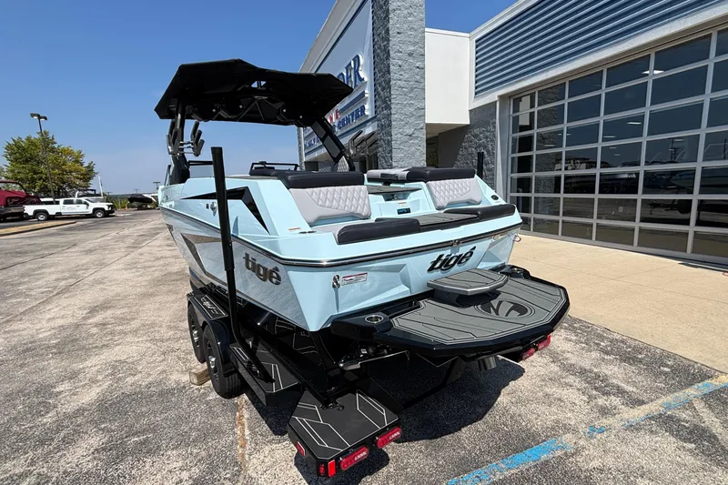 Slide: The Image of 2026 Tigé 24RZX boat parked outside dealership, showcasing sleek design and modern features. - 3