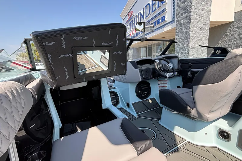Slide: The Image of 2026 Tigé 24RZX boat interior with modern dashboard and seating at a boating center. - 31