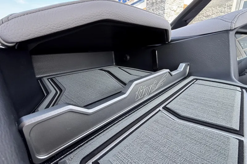 Slide: The Image of 2026 Tigé 24RZX interior storage compartment with logo detailing. - 33