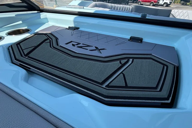 Slide: The Image of 2026 Tigé 24RZX boat interior with RZX logo and cup holders. - 34