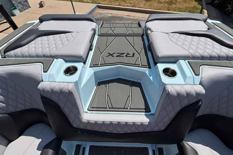 Slide: The Image of 2026 Tigé 24RZX boat interior with quilted seats and cup holders. - 40