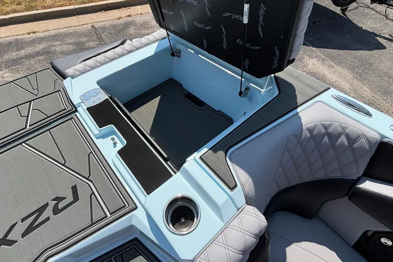 Slide: The Image of 2026 Tigé 24RZX boat interior with open storage compartment and cushioned seating. - 43