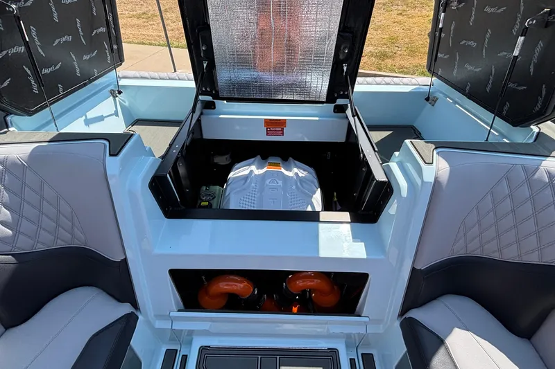 Slide: The Image of 2026 Tigé 24RZX boat interior with open engine compartment, showcasing modern design and seating. - 44