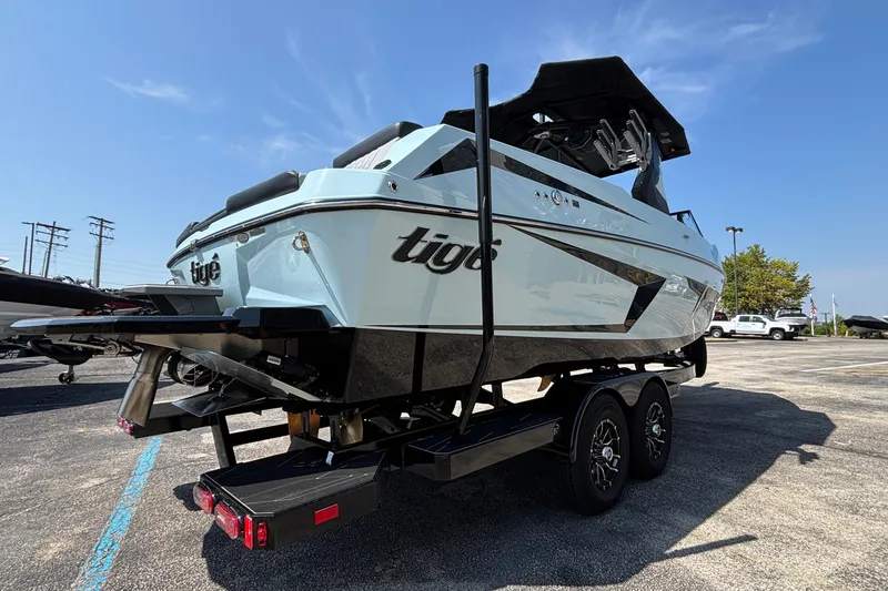 Slide: The Image of 2026 Tigé 24RZX boat on trailer, rear view, parked outdoors under clear sky. - 5