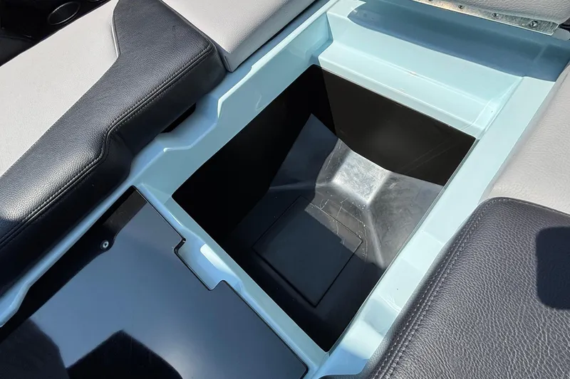Slide: The Image of Storage compartment in 2026 Tigé 24RZX boat, featuring sleek black and gray seating. - 51