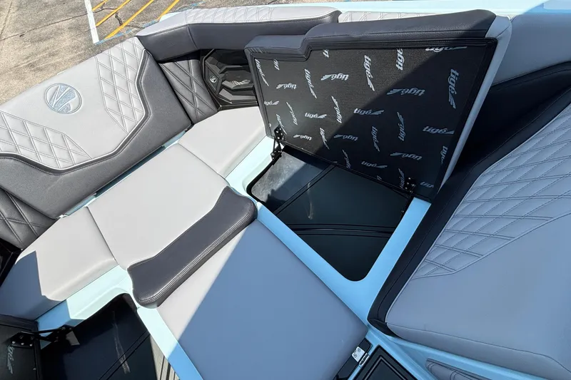 Slide: The Image of 2026 Tigé 24RZX boat interior with stylish gray seating and storage compartments. - 54