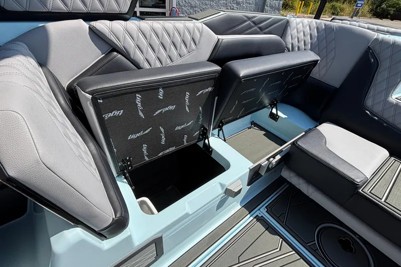 Slide: The Image of 2026 Tigé 24RZX boat interior with open storage compartments and luxurious seating. - 58