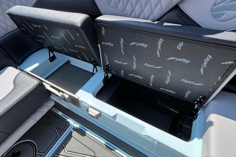 Slide: The Image of 2026 Tigé 24RZX boat interior storage compartments with open cushioned seats. - 59