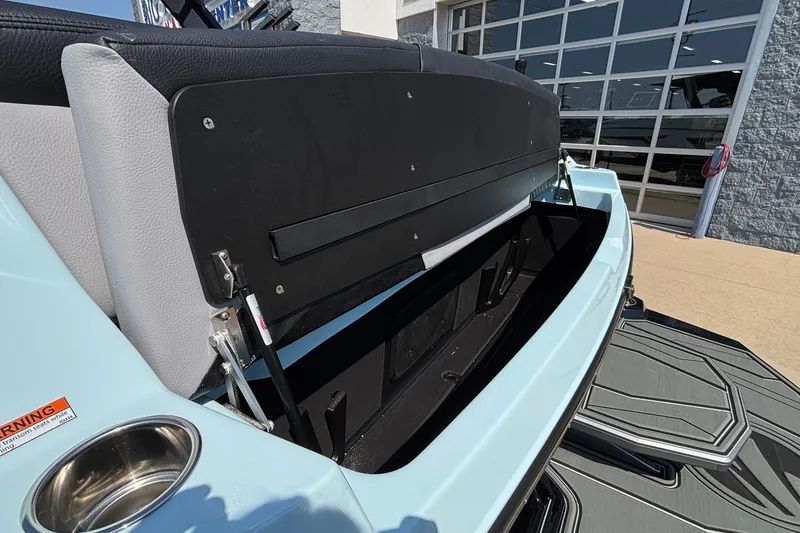 Slide: The Image of 2026 Tigé 24RZX boat with open storage compartment and sleek design. - 63