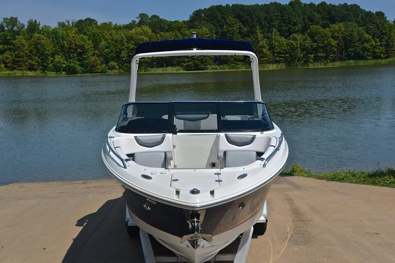 Slide: The Image of 2019 Chaparral 277 SSX boat on trailer by a scenic lake. - 19